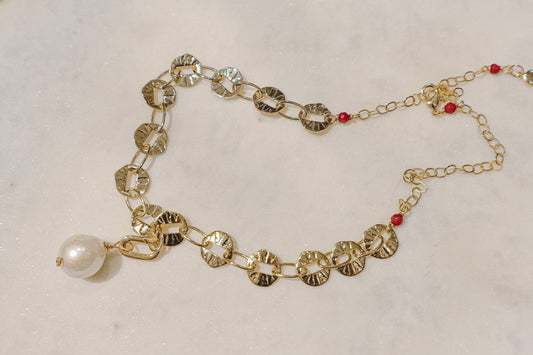 A single baroque pearl suspended on a delicate 18k gold-filled chain.