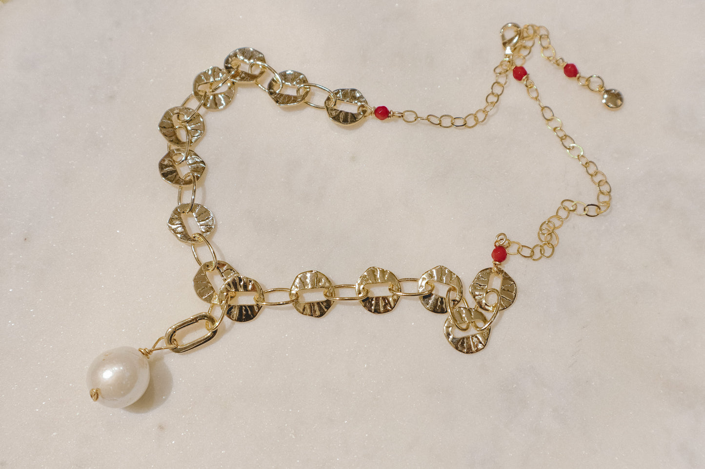 A single baroque pearl suspended on a delicate 18k gold-filled chain.