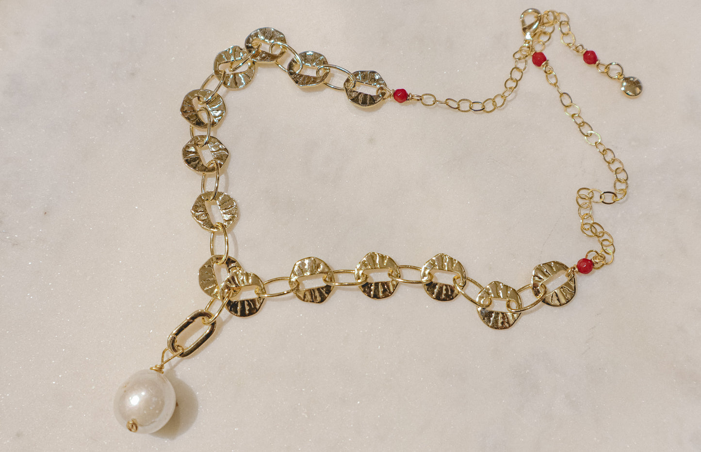 A single baroque pearl suspended on a delicate 18k gold-filled chain.