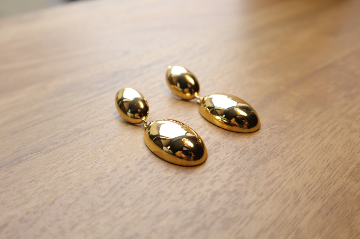 Indulge in timeless sophistication with our 18K Gold Filled Solid Oval Drop Earrings. The lustrous gold and graceful curves exude refined elegance.