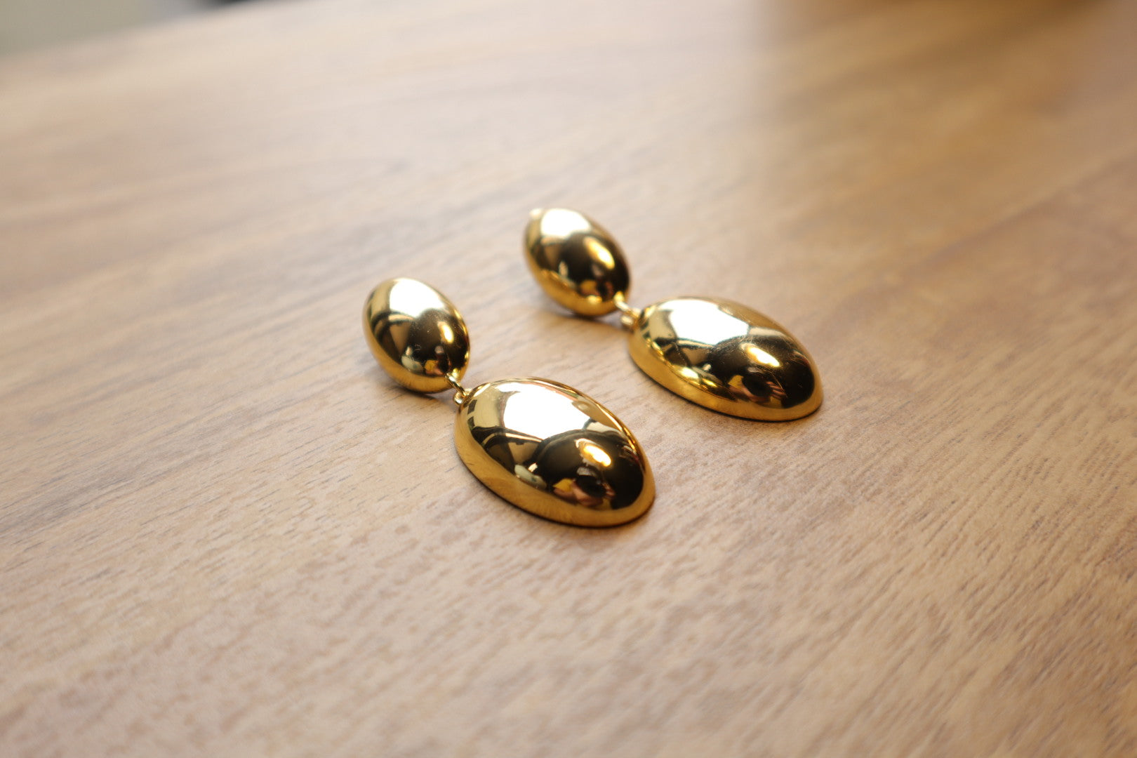 Indulge in timeless sophistication with our 18K Gold Filled Solid Oval Drop Earrings. The lustrous gold and graceful curves exude refined elegance.