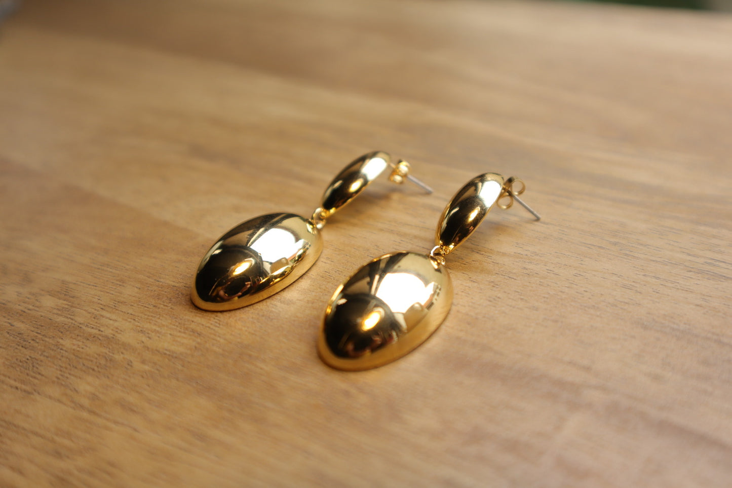 Indulge in timeless sophistication with our 18K Gold Filled Solid Oval Drop Earrings. The lustrous gold and graceful curves exude refined elegance.