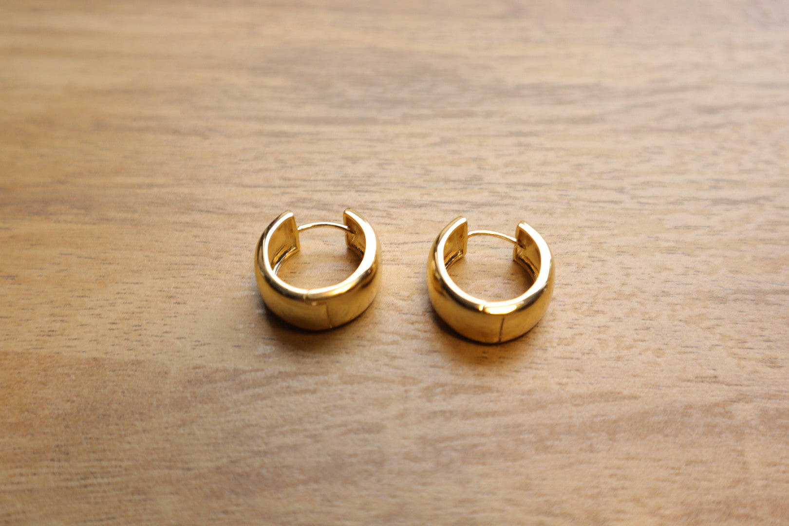 Minimalist luxury. Our 18K gold-filled small thick hoop earrings are the epitome of understated elegance.