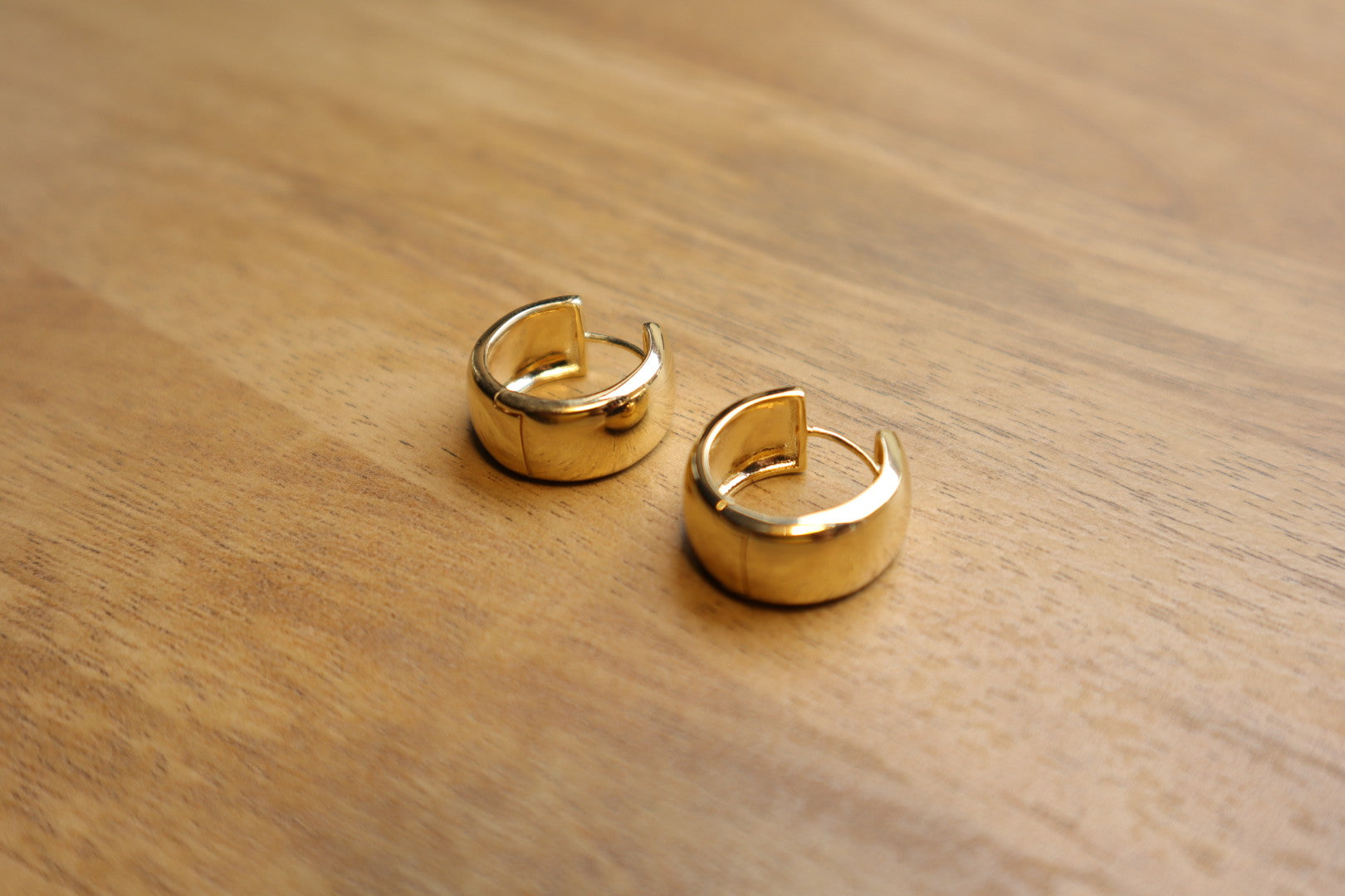Minimalist luxury. Our 18K gold-filled small thick hoop earrings are the epitome of understated elegance.