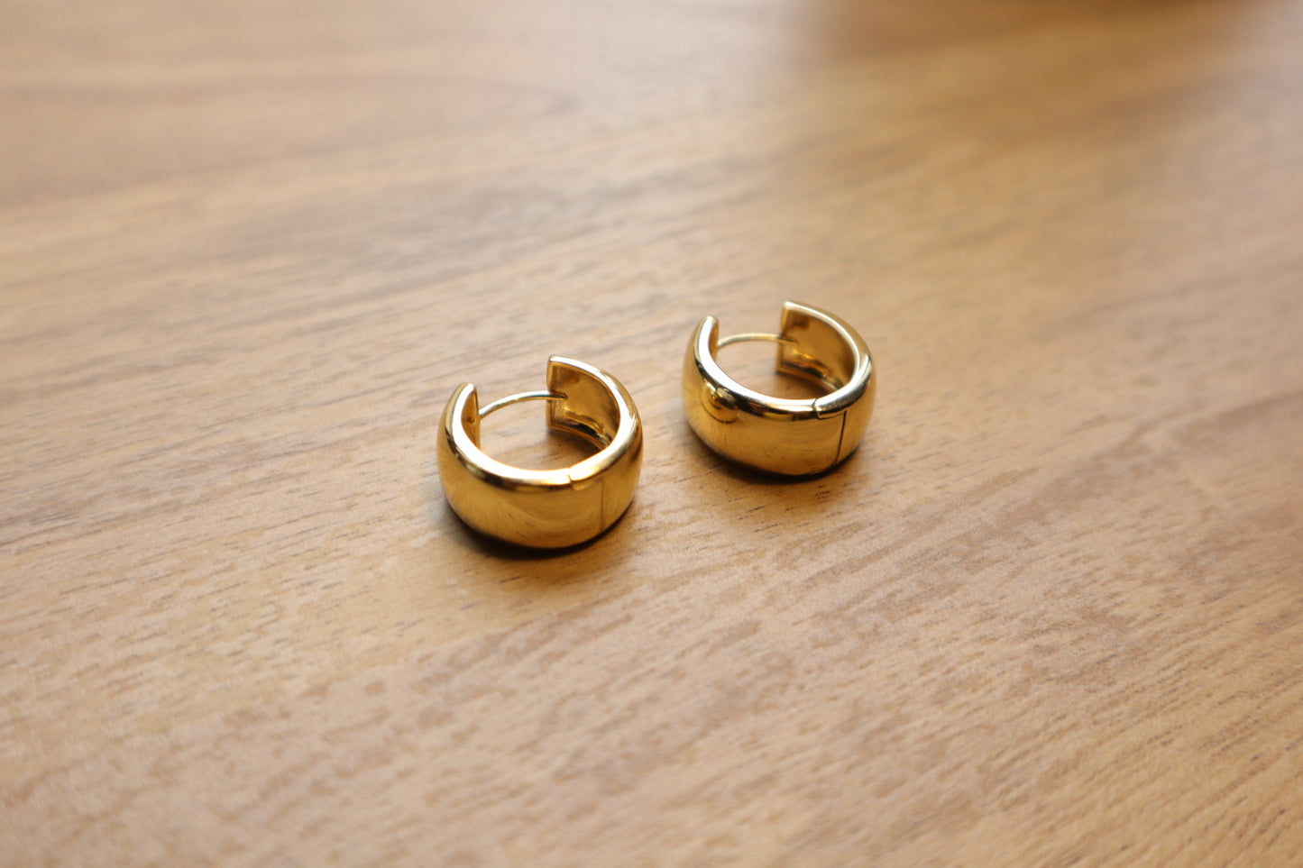 Minimalist luxury. Our 18K gold-filled small thick hoop earrings are the epitome of understated elegance.