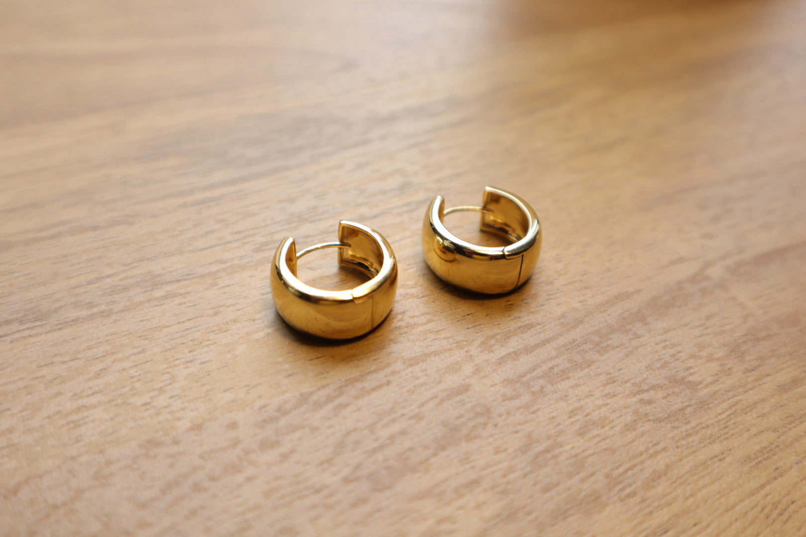 Minimalist luxury. Our 18K gold-filled small thick hoop earrings are the epitome of understated elegance.