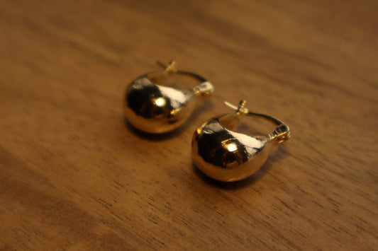 Illuminate your style. Our 18K gold-filled hoop bulb earrings add a touch of playful sophistication.