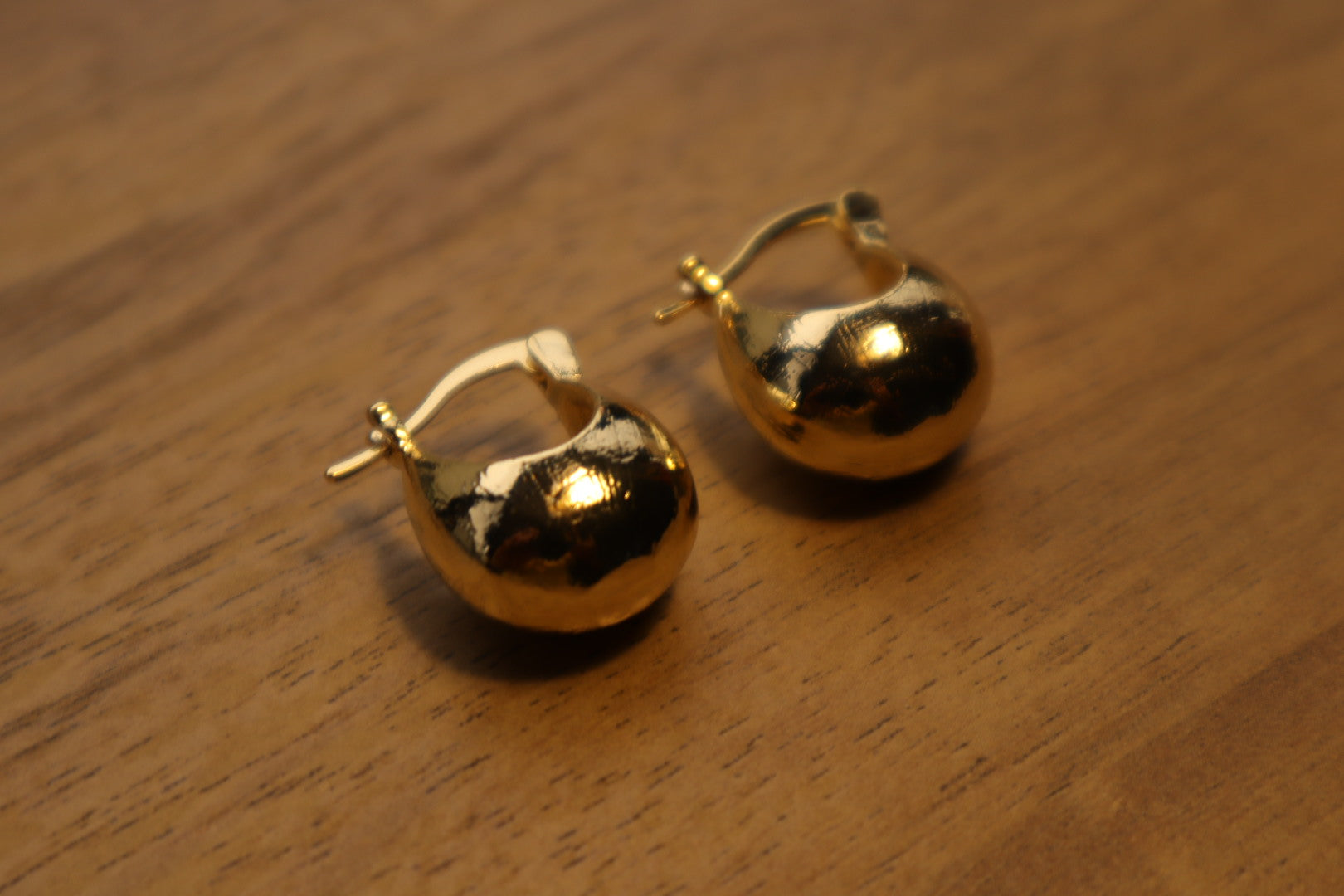 Illuminate your style. Our 18K gold-filled hoop bulb earrings add a touch of playful sophistication.