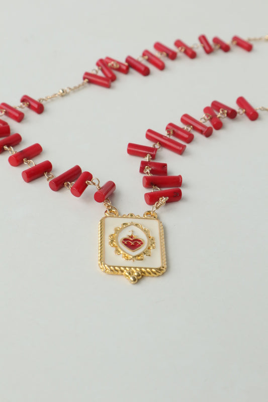 Vibrant coral beads, a touch of the sea, dance on a delicate gold-filled chain, accented by a captivating gold-filled enamel pendant.