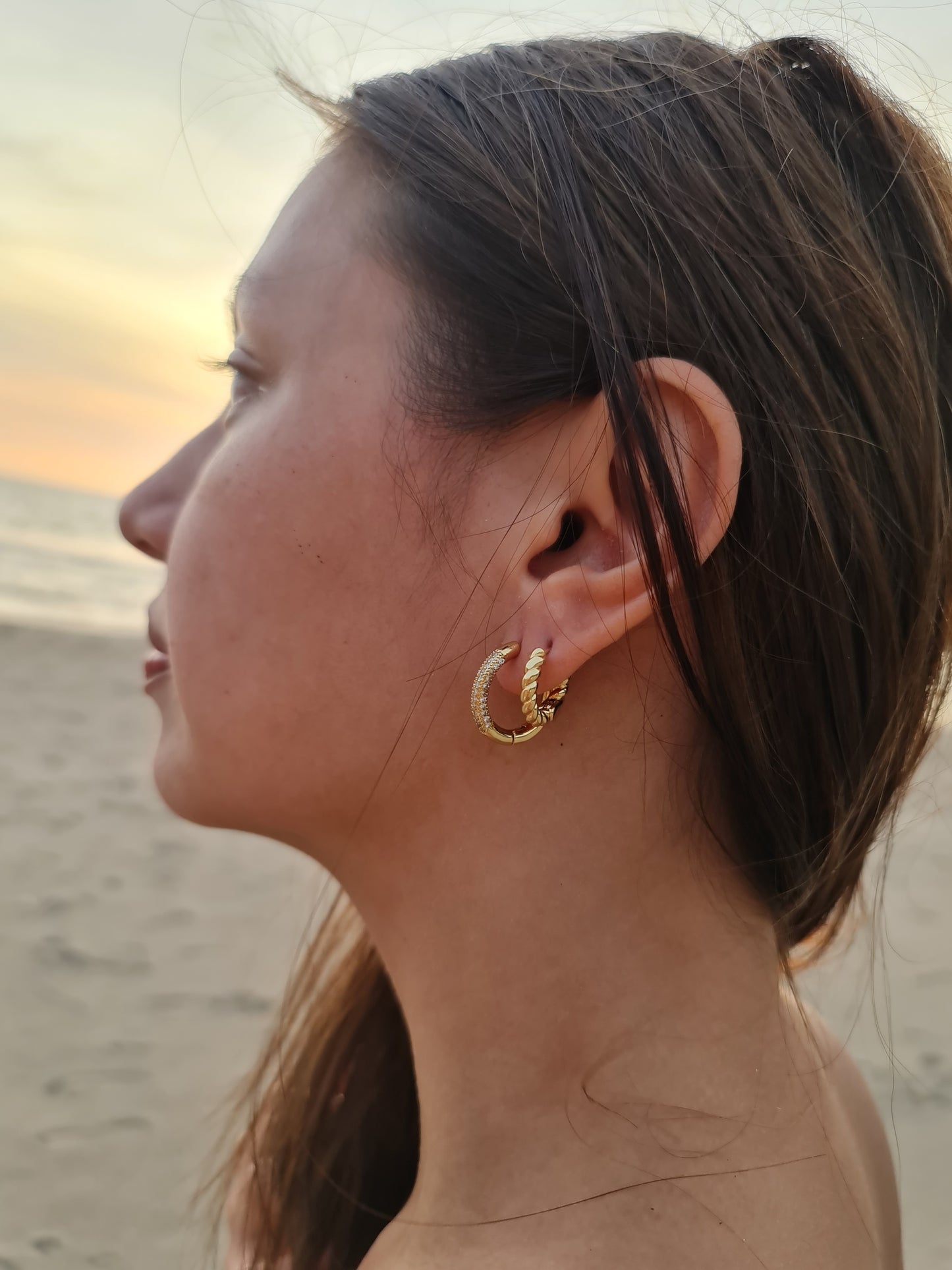 everyday elegant gold filled circle hoop earrings and twisted solid gold worn in the beach