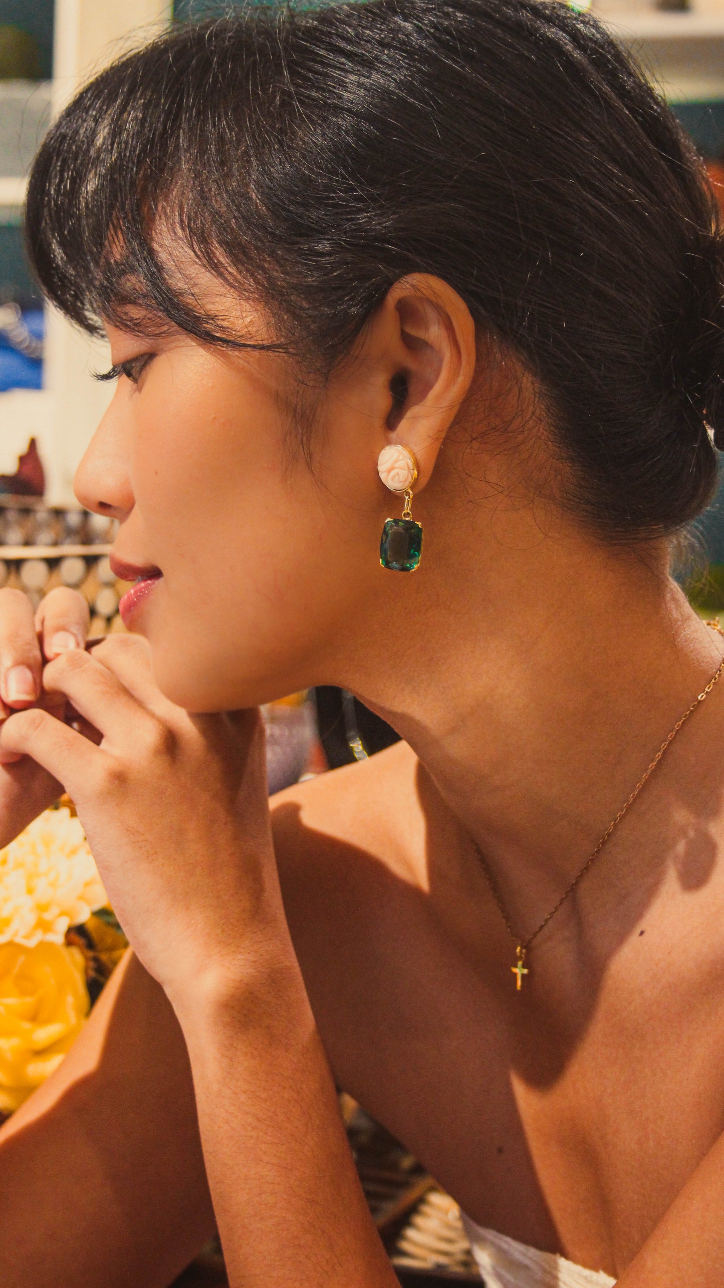 Striking Japanese coral boasts a peach hue, reminiscent of a summer sunset. The coral is juxtaposed with captivating green amethyst gemstones, symbolizing growth and tranquility. Secured in gleaming 18k solid gold settings, these earrings offer a touch of elegance and natural beauty.