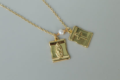 A gold-filled scapular pendant, a traditional symbol of faith, reimagined for modern wear.