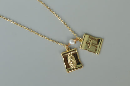 A gold-filled scapular pendant, a traditional symbol of faith, reimagined for modern wear.