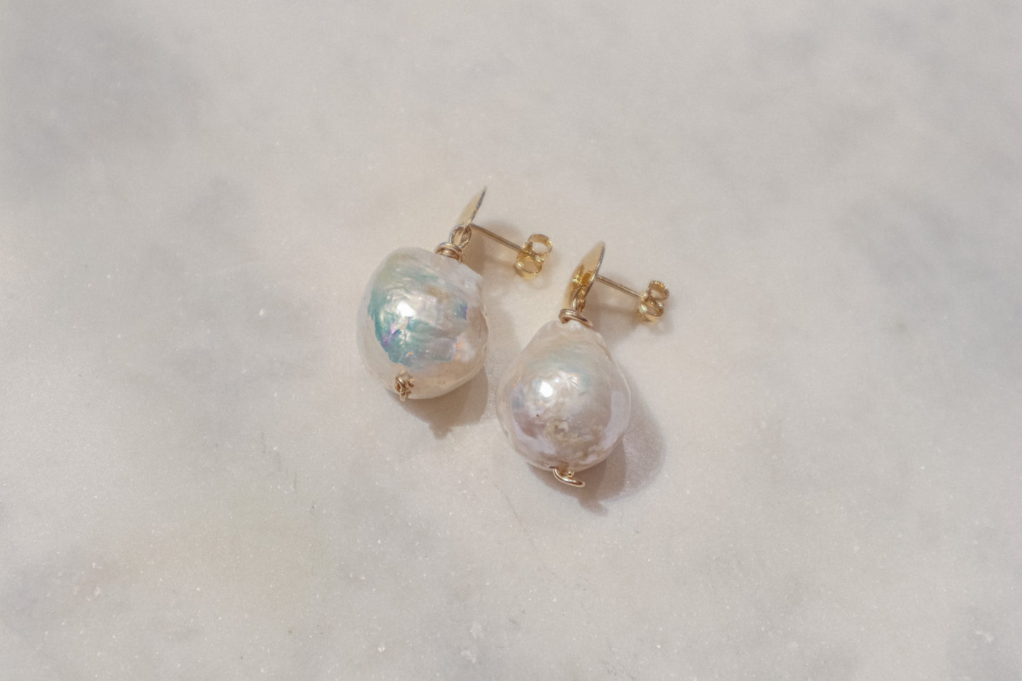 Unleash your inner artist with these captivating South Sea baroque pearl earrings. Each pearl, boasting a captivating range of shapes and textures, is a celebration of nature's unique beauty. Secured by comfortable gold-filled disk posts, these earrings add a touch of flair to any outfit.