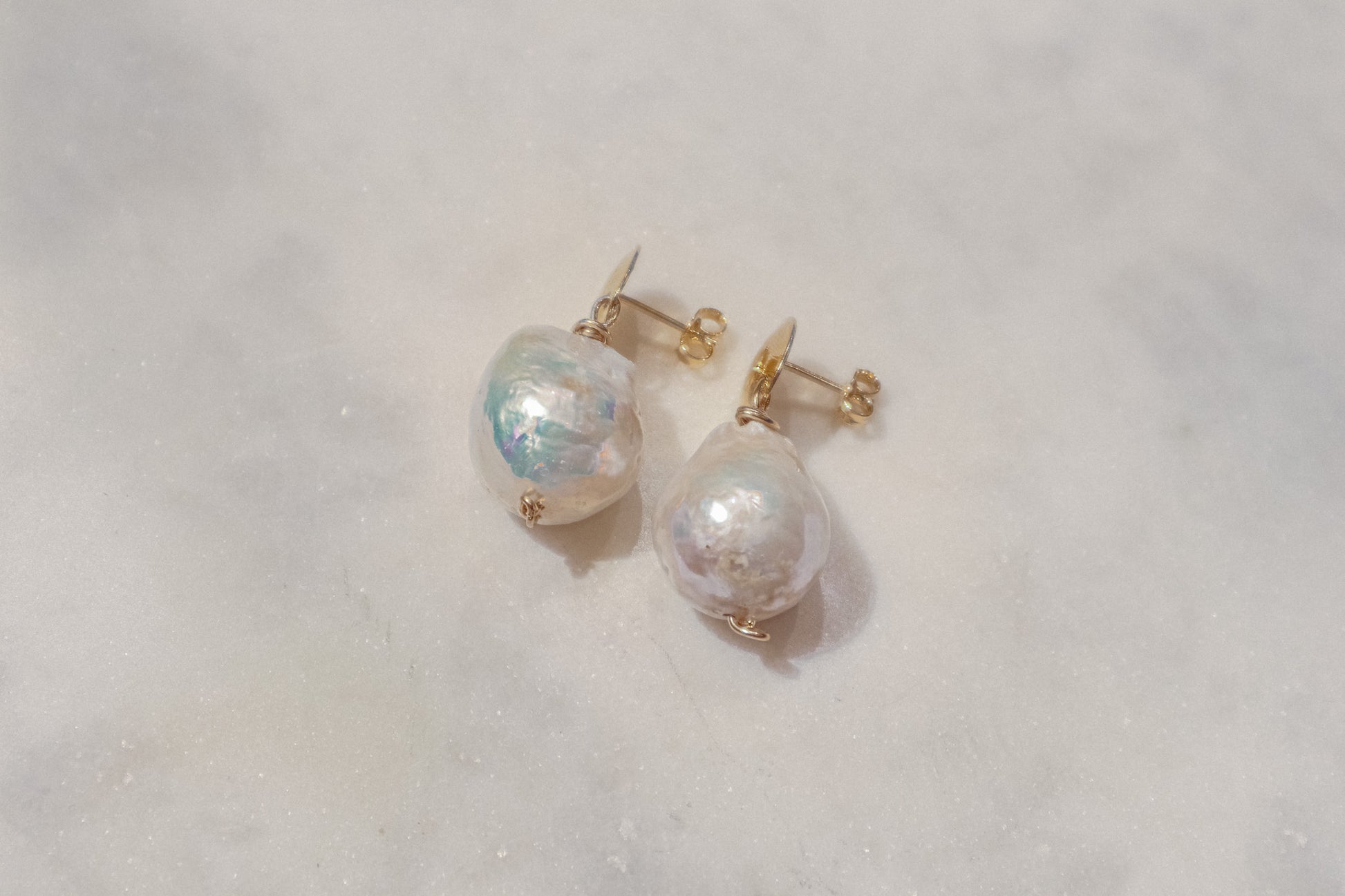 Unleash your inner artist with these captivating South Sea baroque pearl earrings. Each pearl, boasting a captivating range of shapes and textures, is a celebration of nature's unique beauty. Secured by comfortable gold-filled disk posts, these earrings add a touch of flair to any outfit.