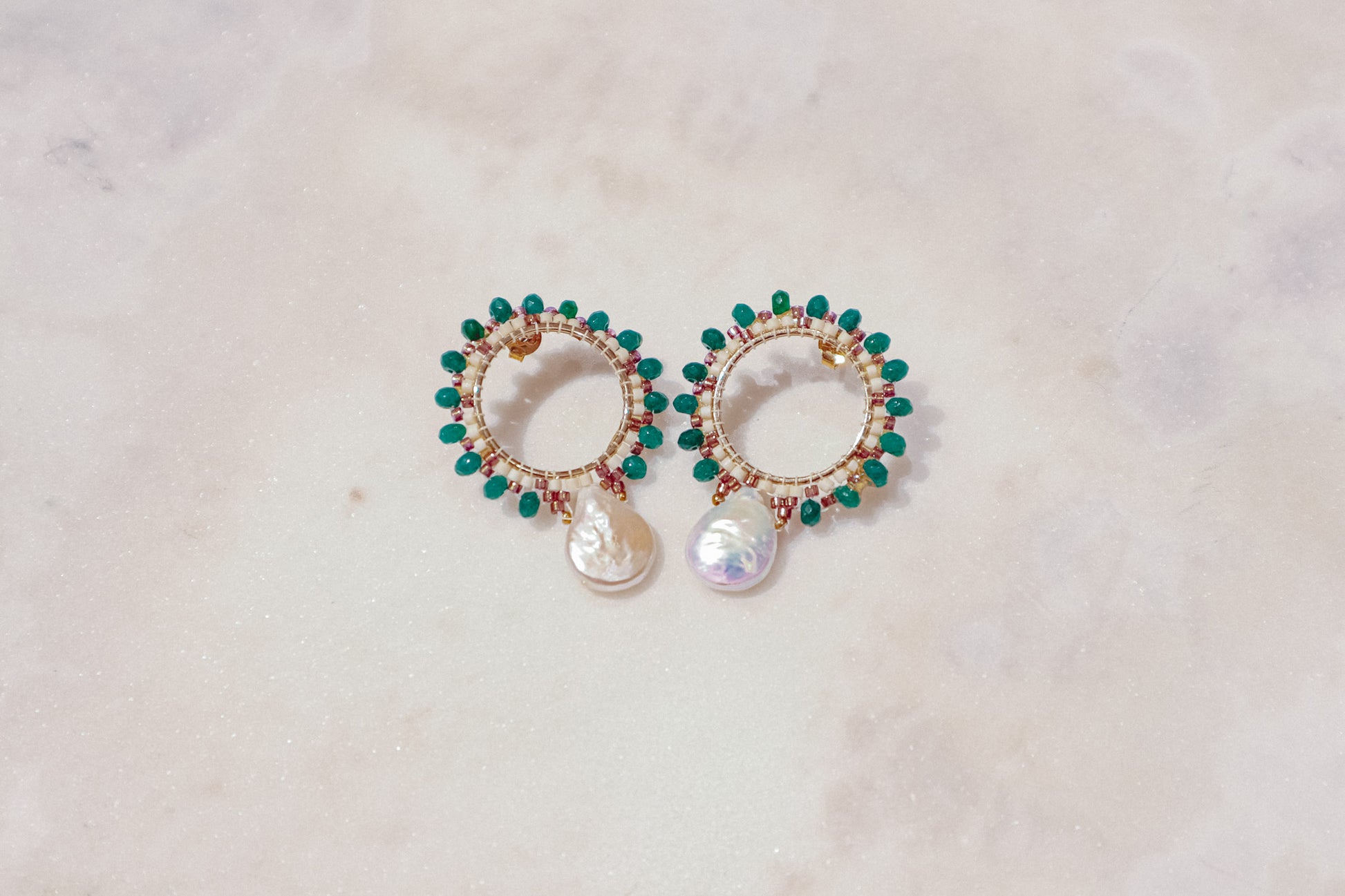 Baroque pearls find unexpected harmony with vibrant emerald agate rondelles in these unique gold-filled post earrings.