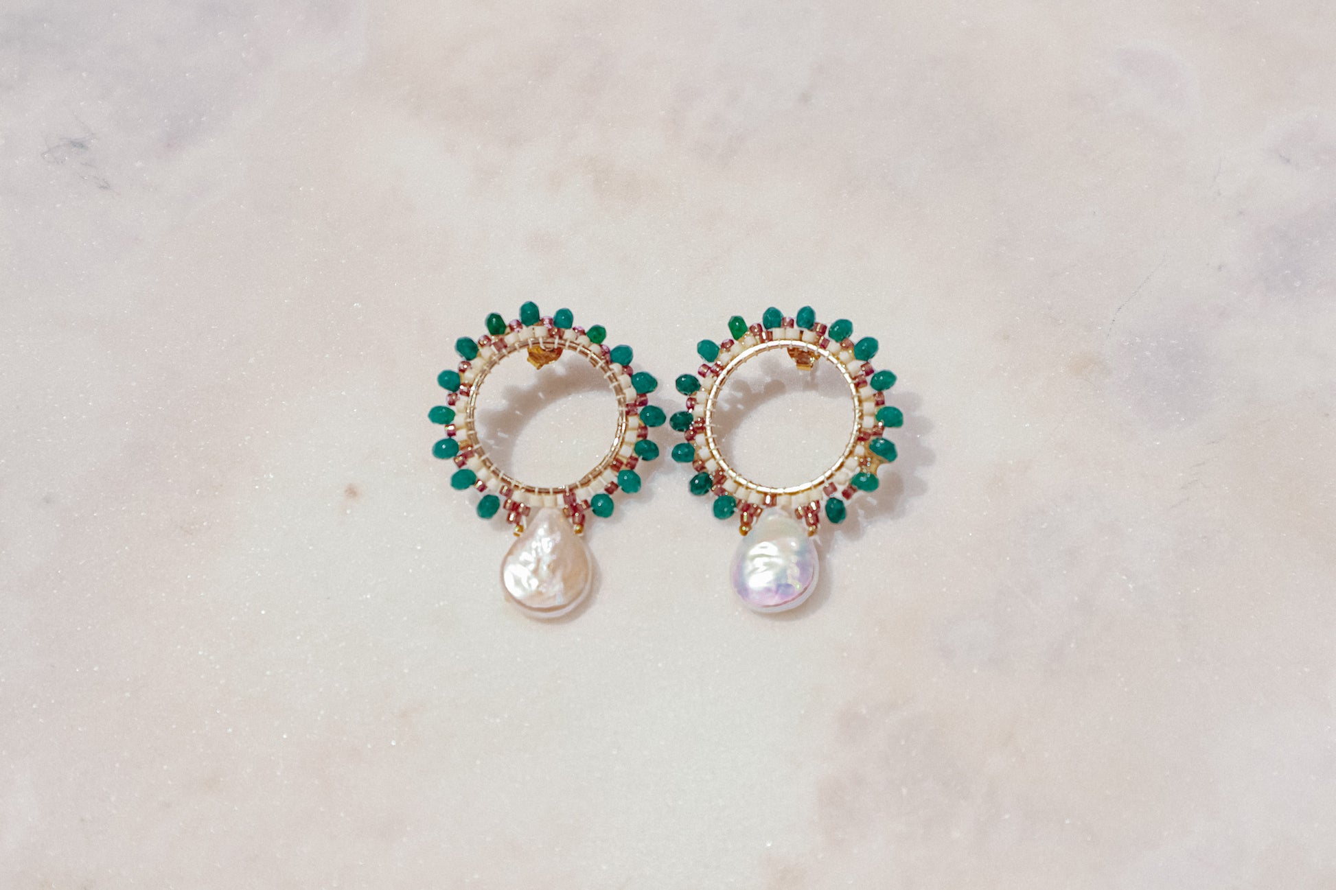 Baroque pearls find unexpected harmony with vibrant emerald agate rondelles in these unique gold-filled post earrings.