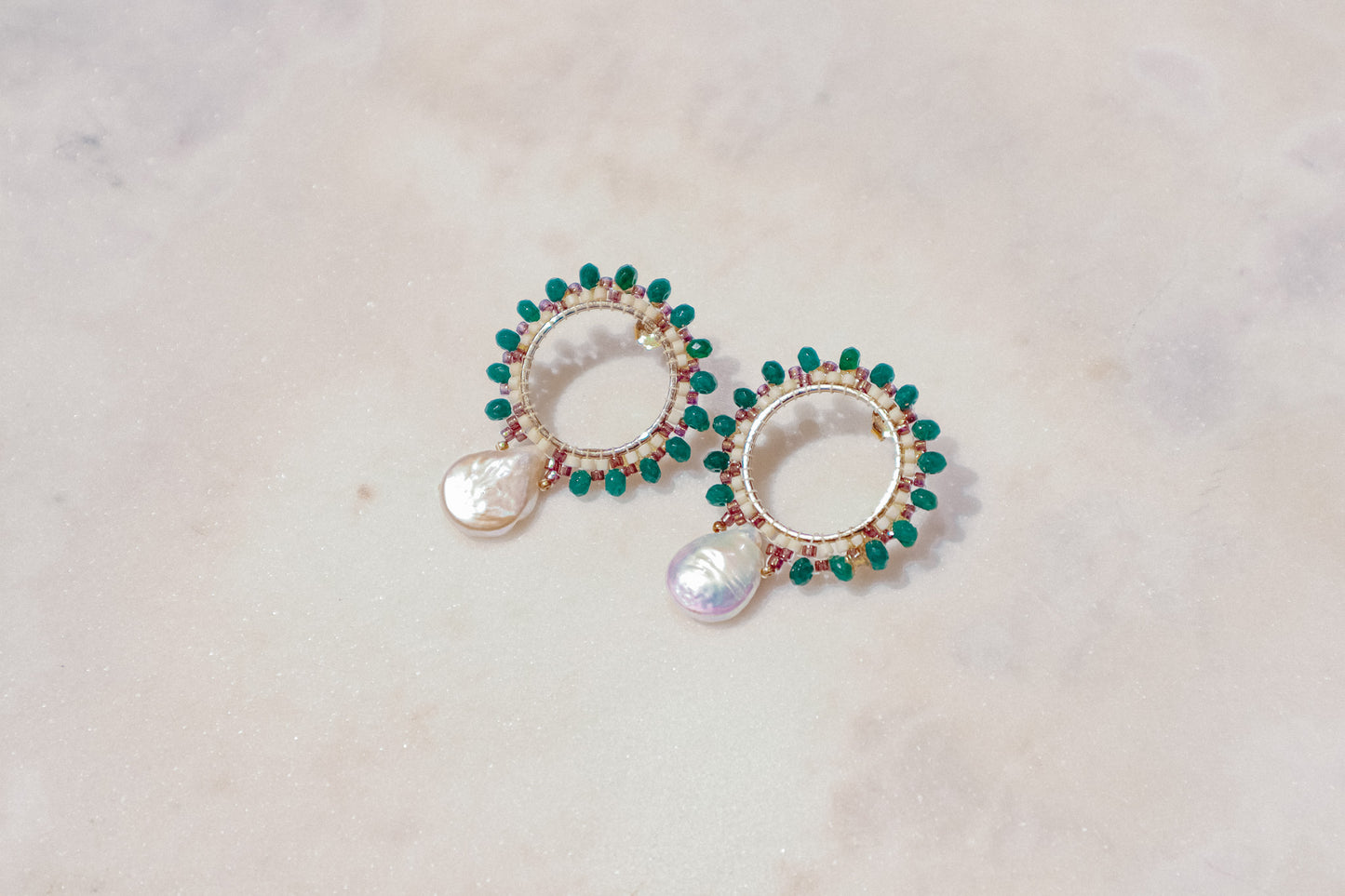 Baroque pearls find unexpected harmony with vibrant emerald agate rondelles in these unique gold-filled post earrings.