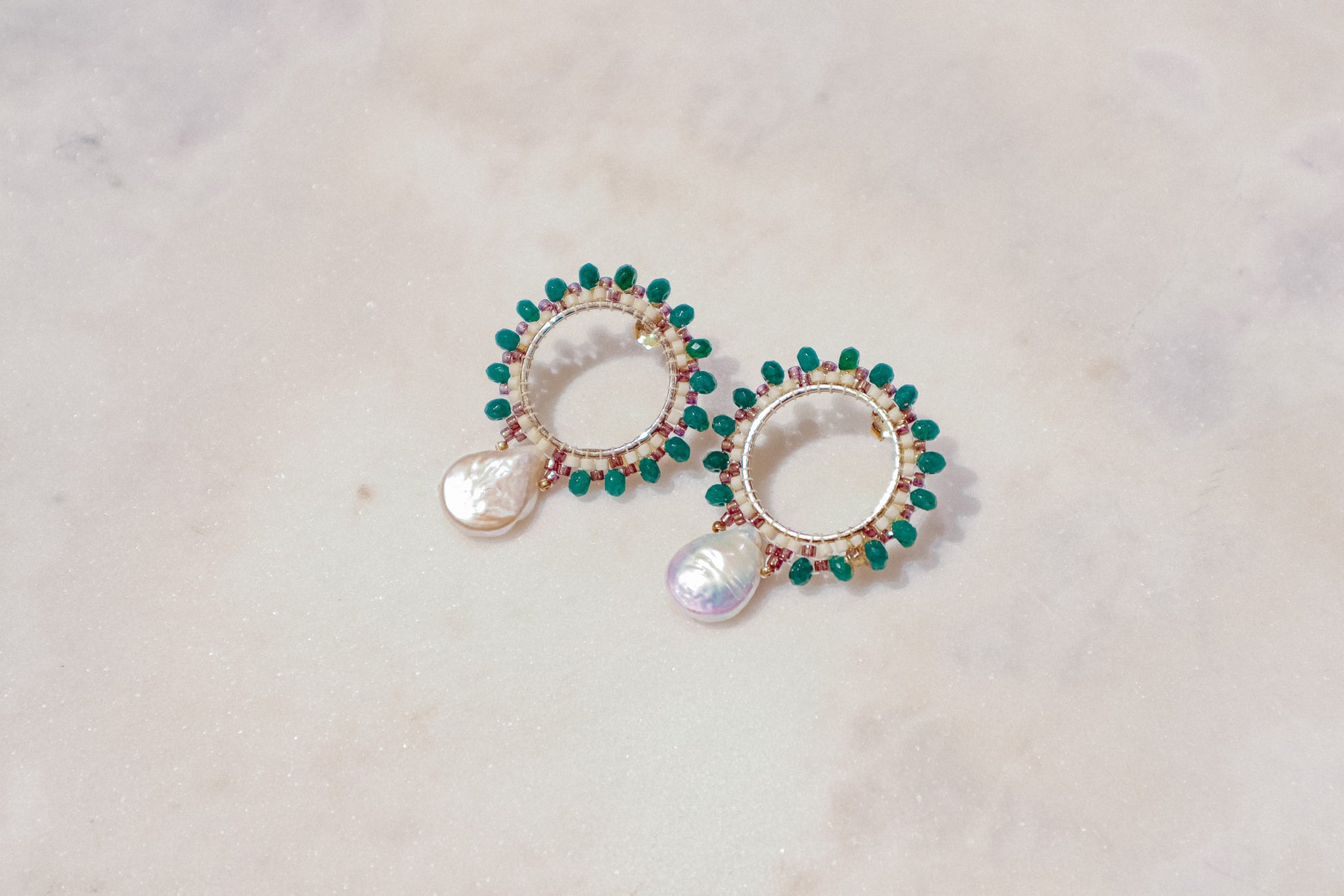 Baroque pearls find unexpected harmony with vibrant emerald agate rondelles in these unique gold-filled post earrings.