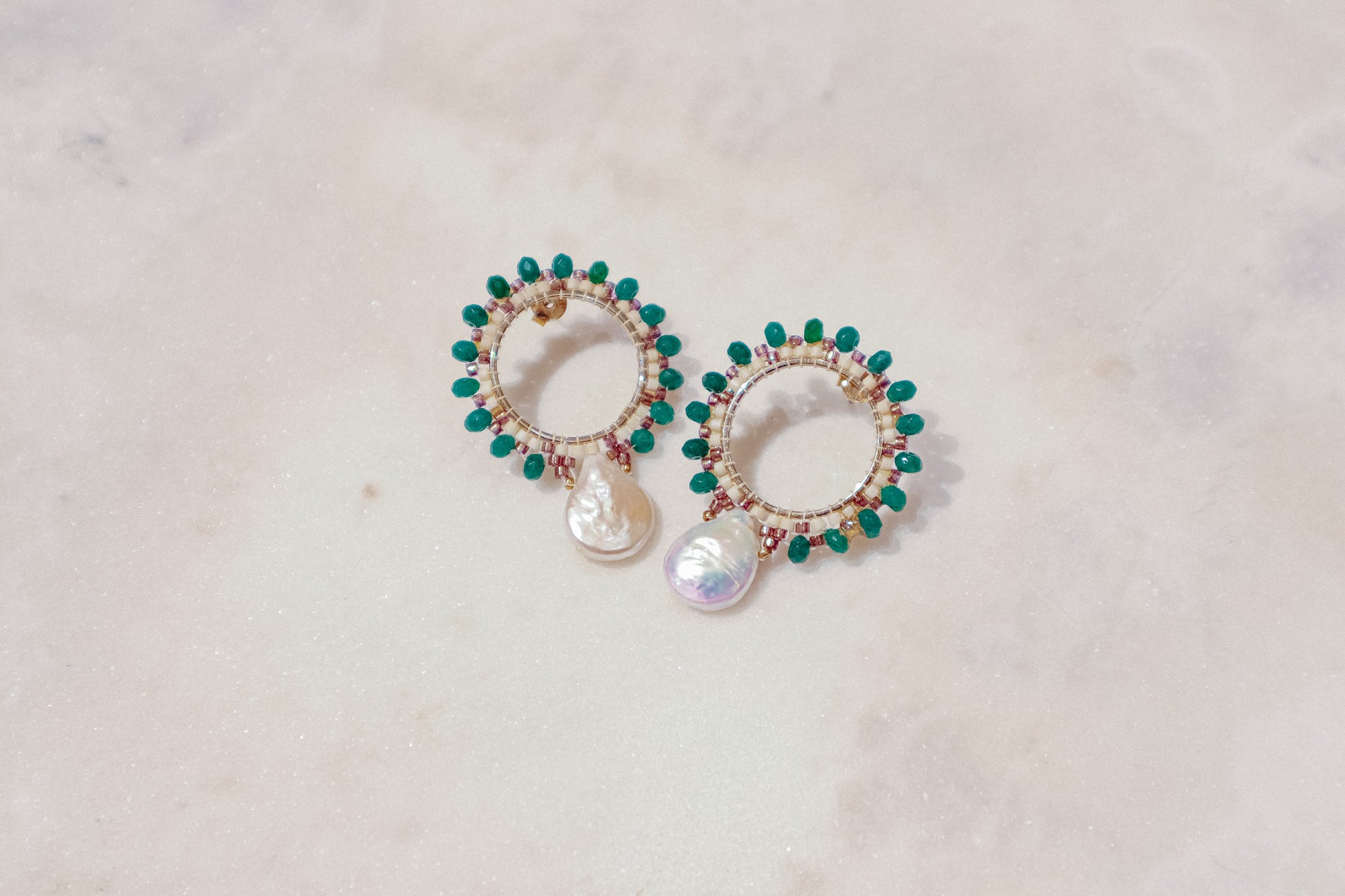 Baroque pearls find unexpected harmony with vibrant emerald agate rondelles in these unique gold-filled post earrings.