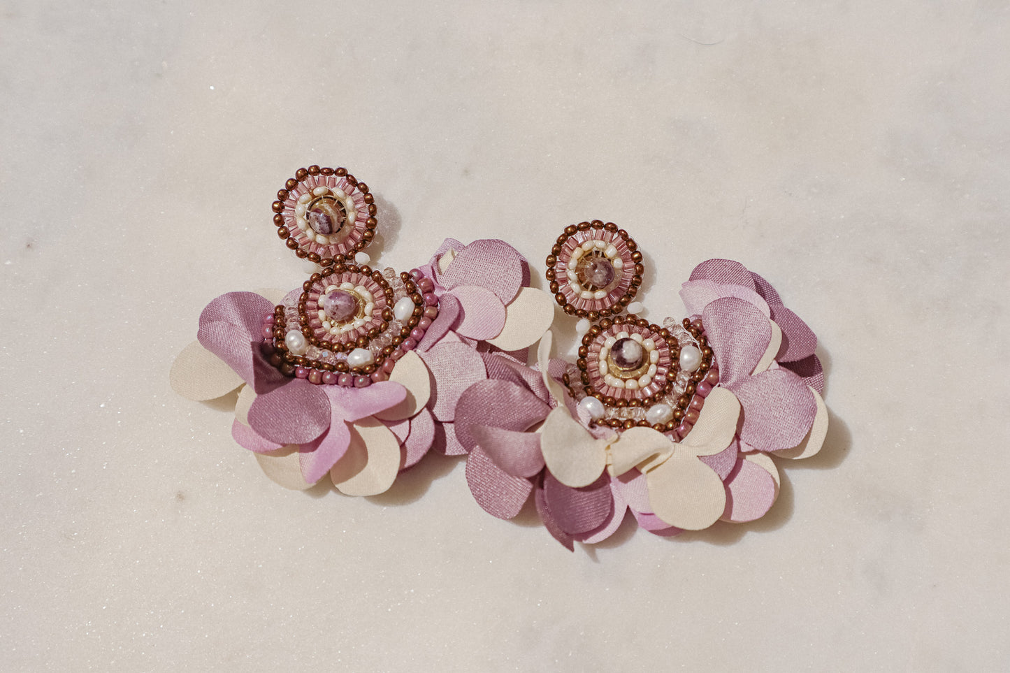 Fabric blooms meet the rich hues of amethyst and the classic elegance of pearls for a touch of timeless beauty on these Flower Fan earrings.