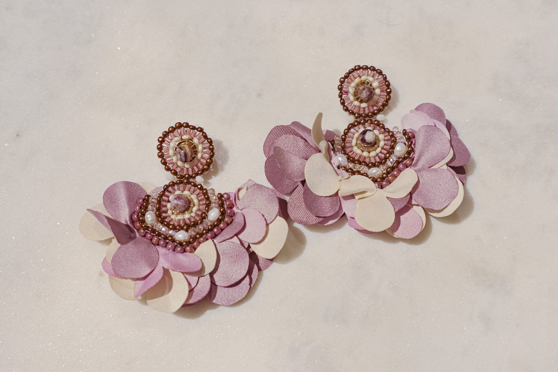 Fabric blooms meet the rich hues of amethyst and the classic elegance of pearls for a touch of timeless beauty on these Flower Fan earrings.