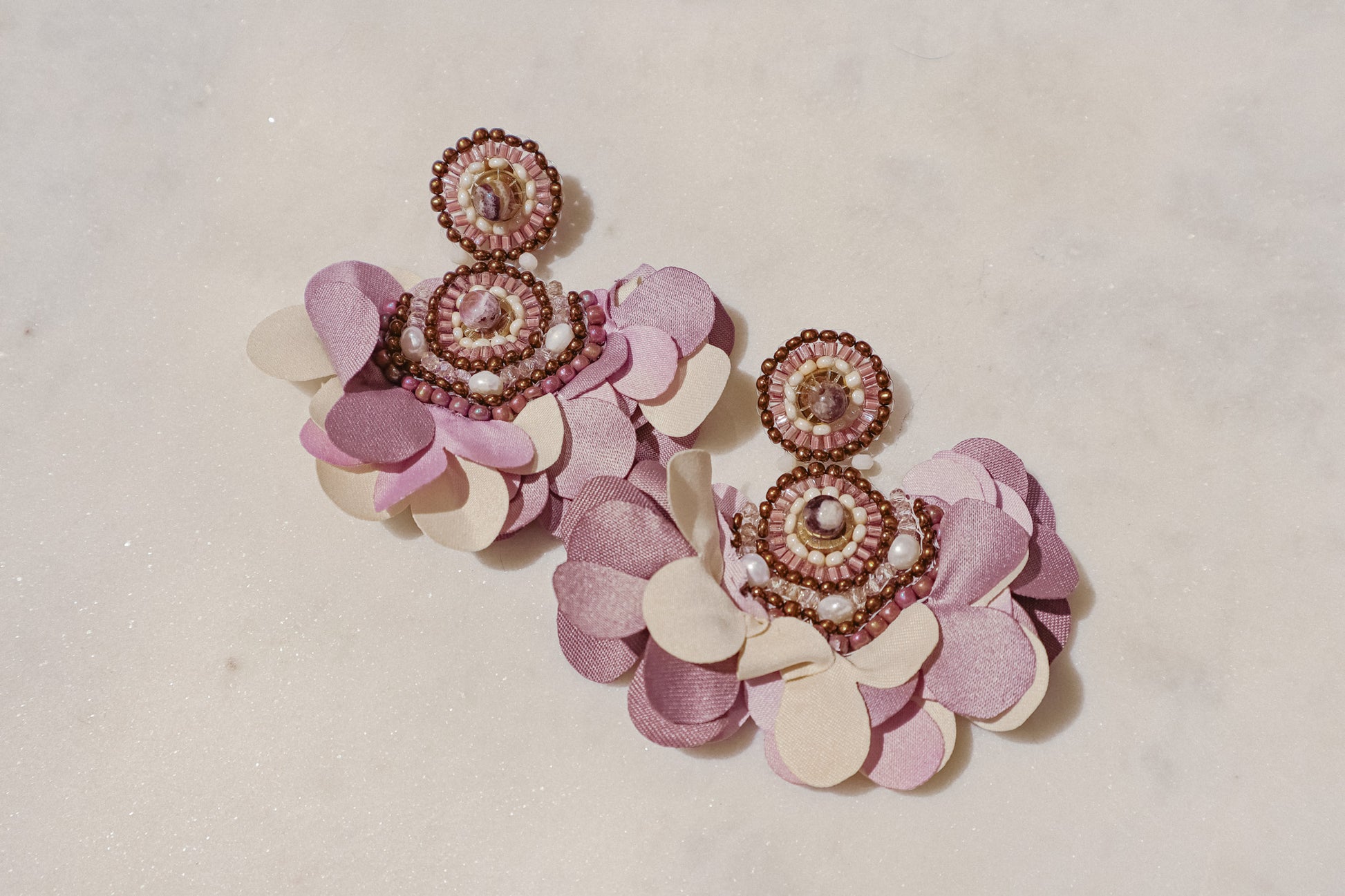 Fabric blooms meet the rich hues of amethyst and the classic elegance of pearls for a touch of timeless beauty on these Flower Fan earrings.