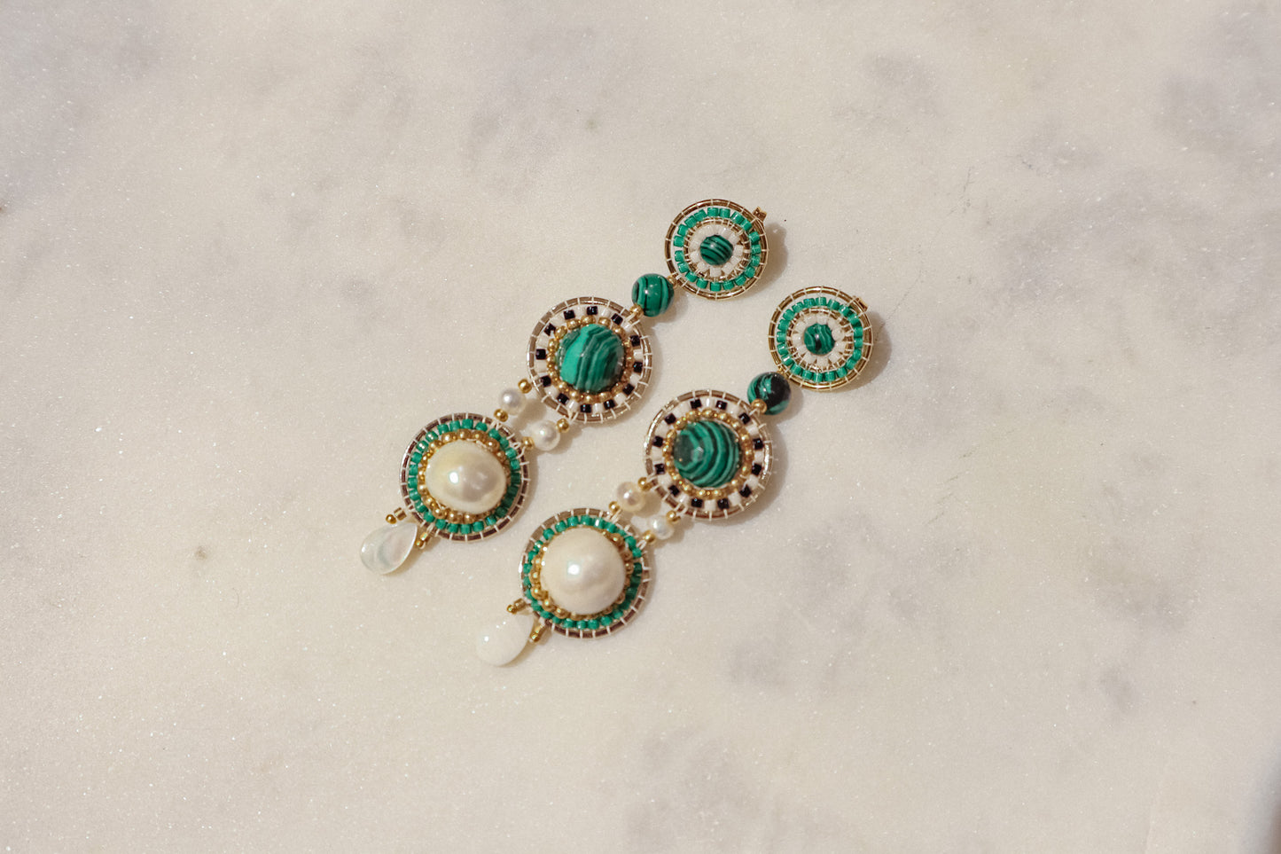 Freshwater pearls meet shimmering Miyuki beads and vibrant malachite, accented by delicate mother-of-pearl petals in gleaming gold-filled settings in these stand out earrings.