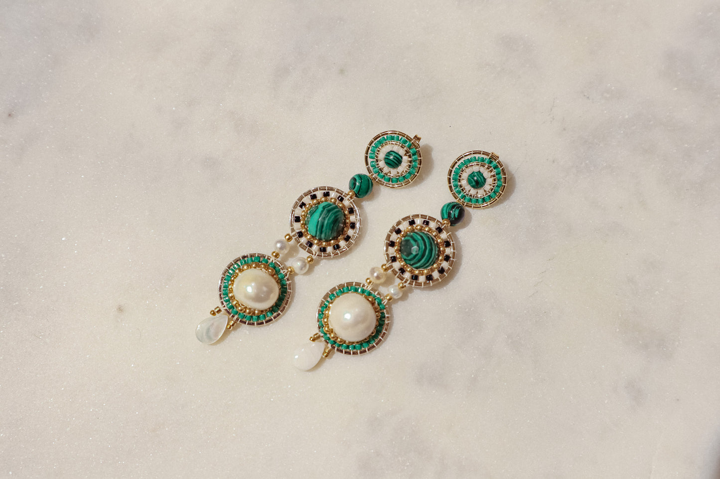 Freshwater pearls meet shimmering Miyuki beads and vibrant malachite, accented by delicate mother-of-pearl petals in gleaming gold-filled settings in these stand out earrings.