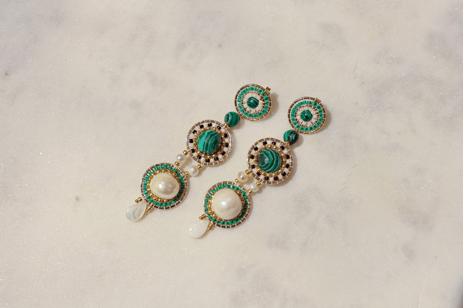 Freshwater pearls meet shimmering Miyuki beads and vibrant malachite, accented by delicate mother-of-pearl petals in gleaming gold-filled settings in these stand out earrings.