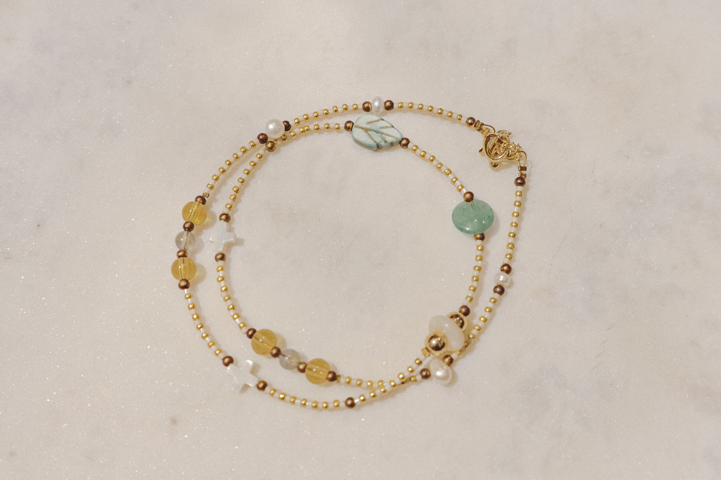 Luminous pearls, sparkling citrine, and refreshing peridot gemstones dance on a delicate gold-filled chain. A touch of summer joy for any occasion.