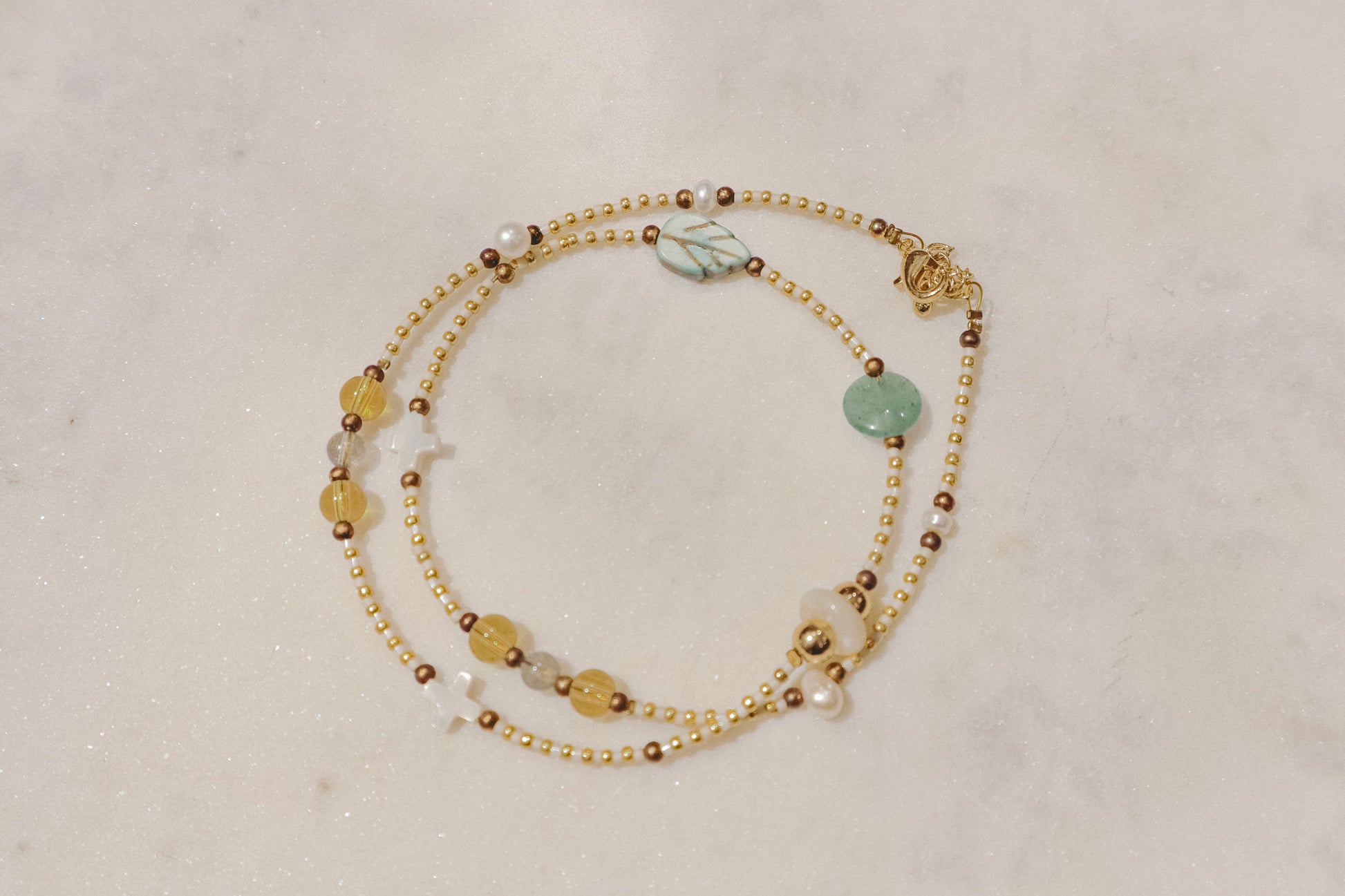 Luminous pearls, sparkling citrine, and refreshing peridot gemstones dance on a delicate gold-filled chain. A touch of summer joy for any occasion.