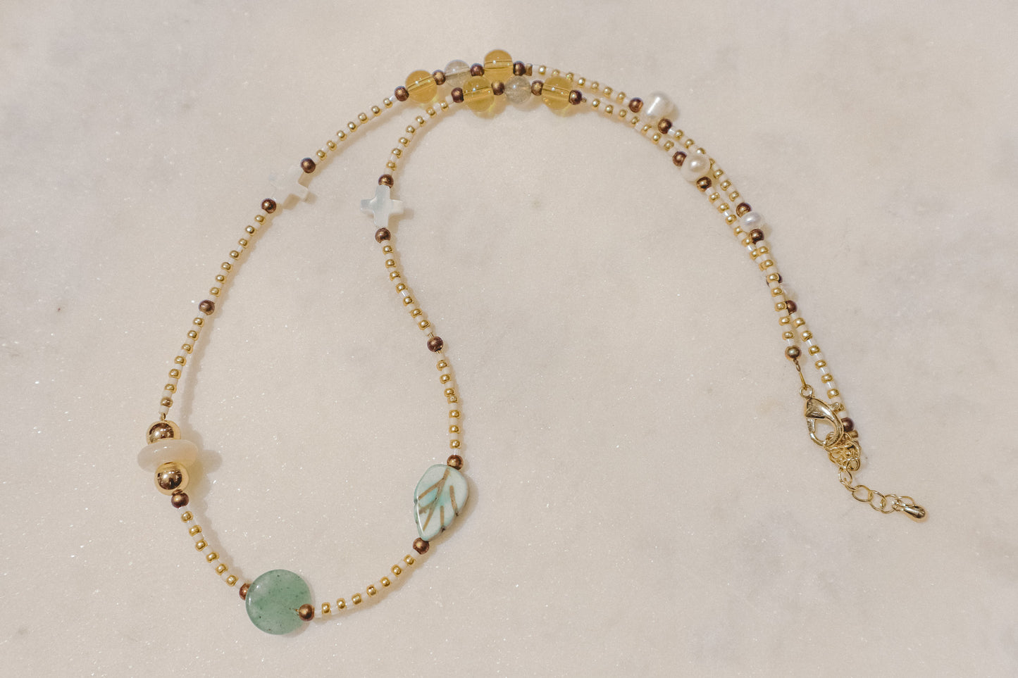 Luminous pearls, sparkling citrine, and refreshing peridot gemstones dance on a delicate gold-filled chain. A touch of summer joy for any occasion.