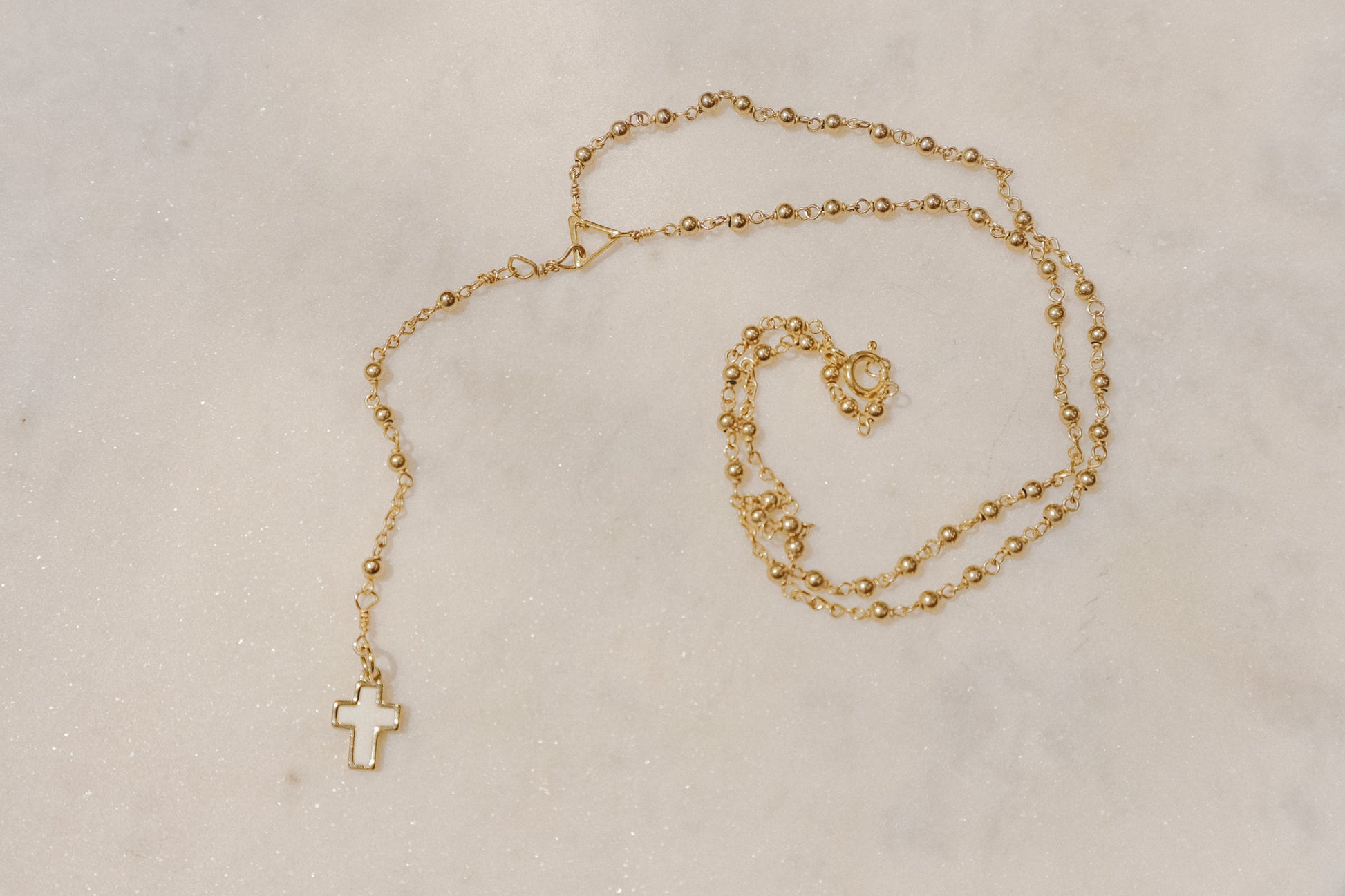 A touch of grace. 18k rose gold-filled rosary necklace with a beautiful mother-of-pearl cross.