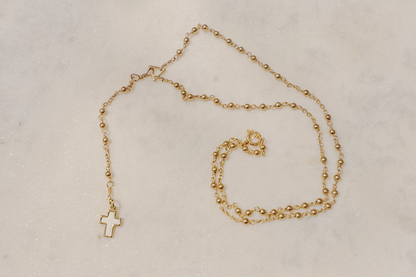 A touch of grace. 18k rose gold-filled rosary necklace with a beautiful mother-of-pearl cross.