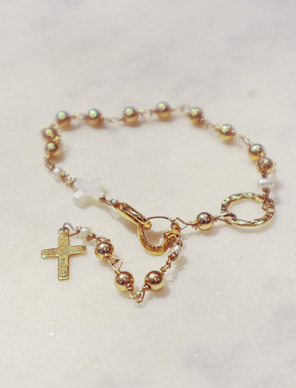 A delicate gold-filled ball chain dances around your ankle along with a Mother-of-Pearl cross culminating in a gold-filled cross.