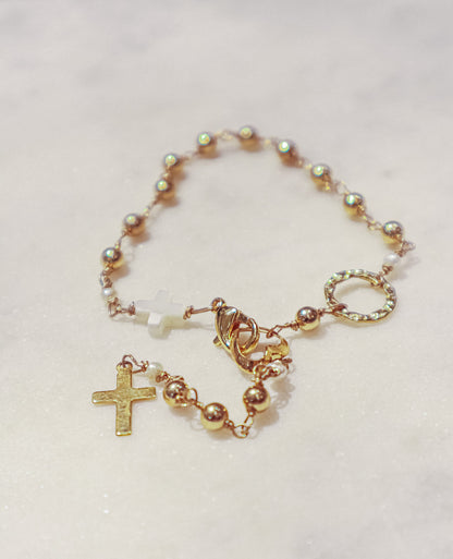 A delicate gold-filled ball chain dances around your ankle along with a Mother-of-Pearl cross culminating in a gold-filled cross.