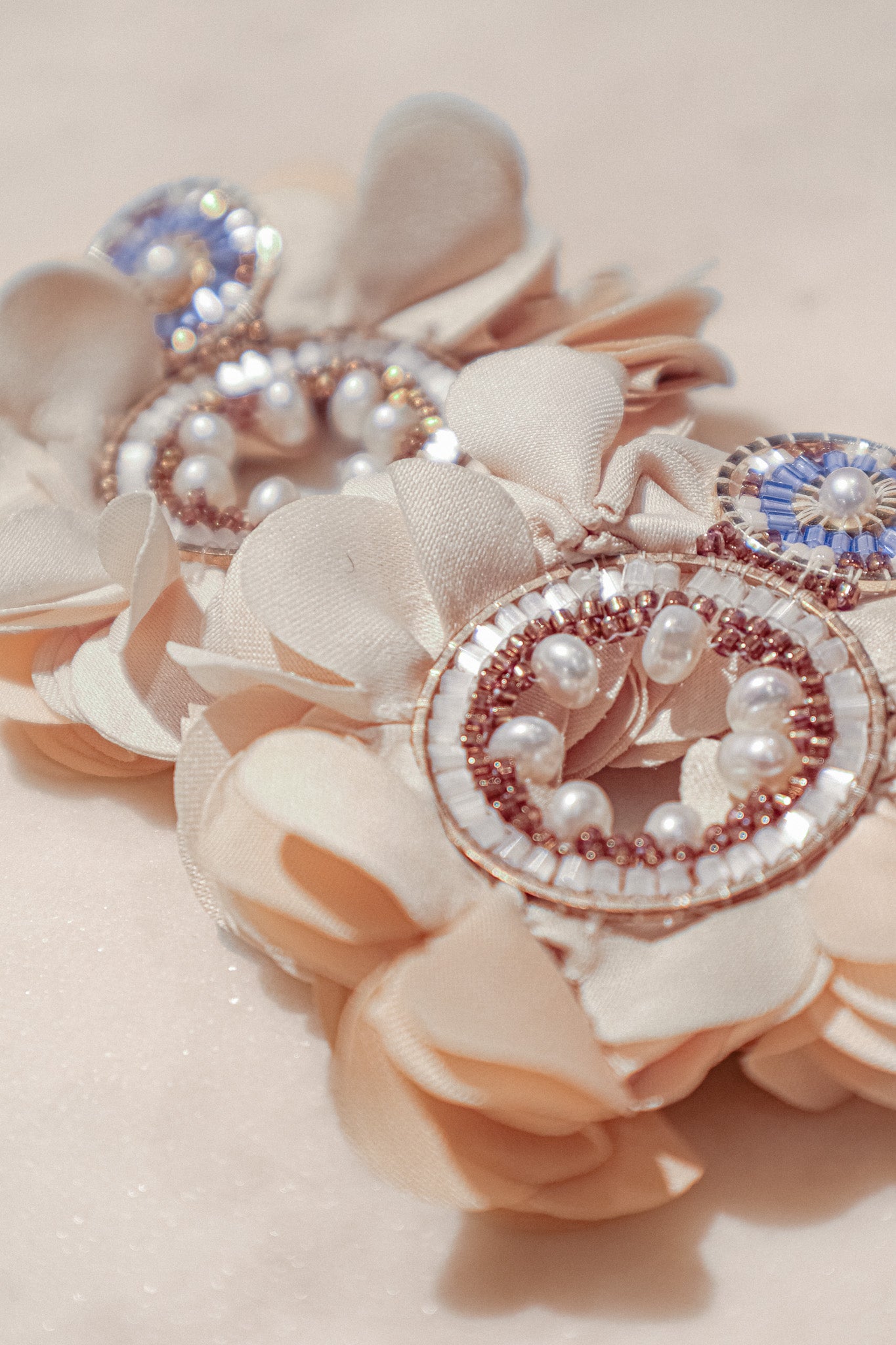 Featuring delicate fabric flowers, gleaming pearls, and sparkling Miyuki beads, these earrings are a testament to handcrafted charm.