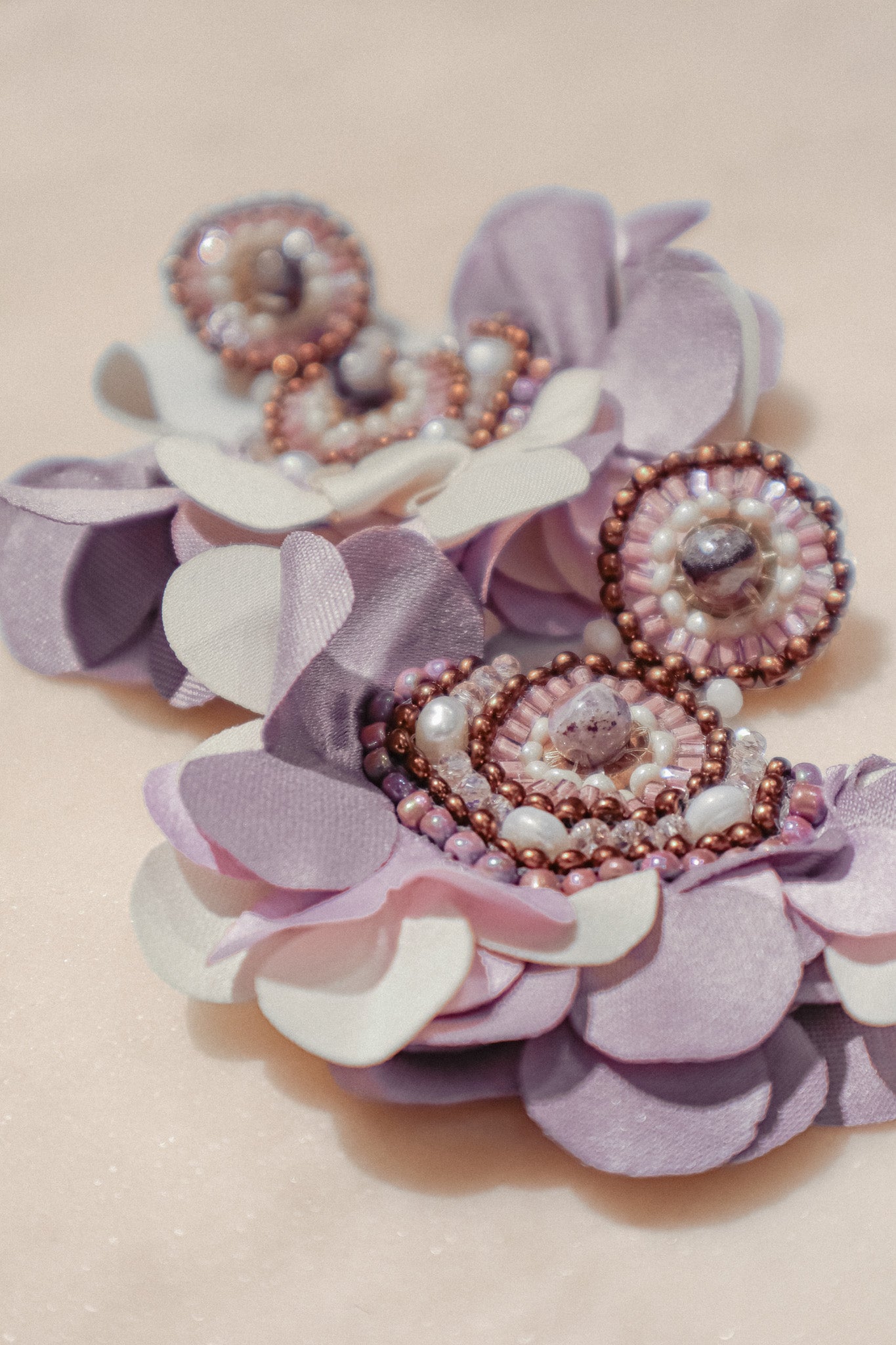 Fabric blooms meet the rich hues of amethyst and the classic elegance of pearls for a touch of timeless beauty on these Flower Fan earrings.