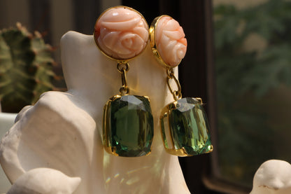 Indulge in a captivating interplay of color with these 18k solid gold earrings. Striking Japanese coral boasts a peach hue, reminiscent of a summer sunset. The coral is juxtaposed with captivating green amethyst gemstones, symbolizing growth and tranquility. Secured in gleaming 18k solid gold settings, these earrings offer a touch of elegance and natural beauty.