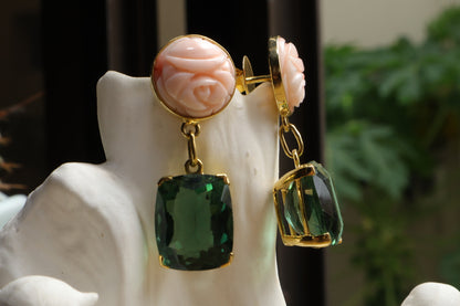 Indulge in a captivating interplay of color with these 18k solid gold earrings. Striking Japanese coral boasts a peach hue, reminiscent of a summer sunset. The coral is juxtaposed with captivating green amethyst gemstones, symbolizing growth and tranquility. Secured in gleaming 18k solid gold settings, these earrings offer a touch of elegance and natural beauty.