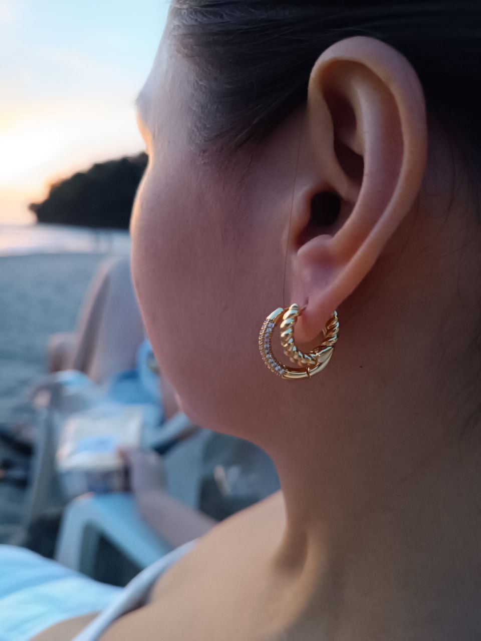 everyday elegant gold filled circle hoop earrings and twisted solid gold worn in the beach