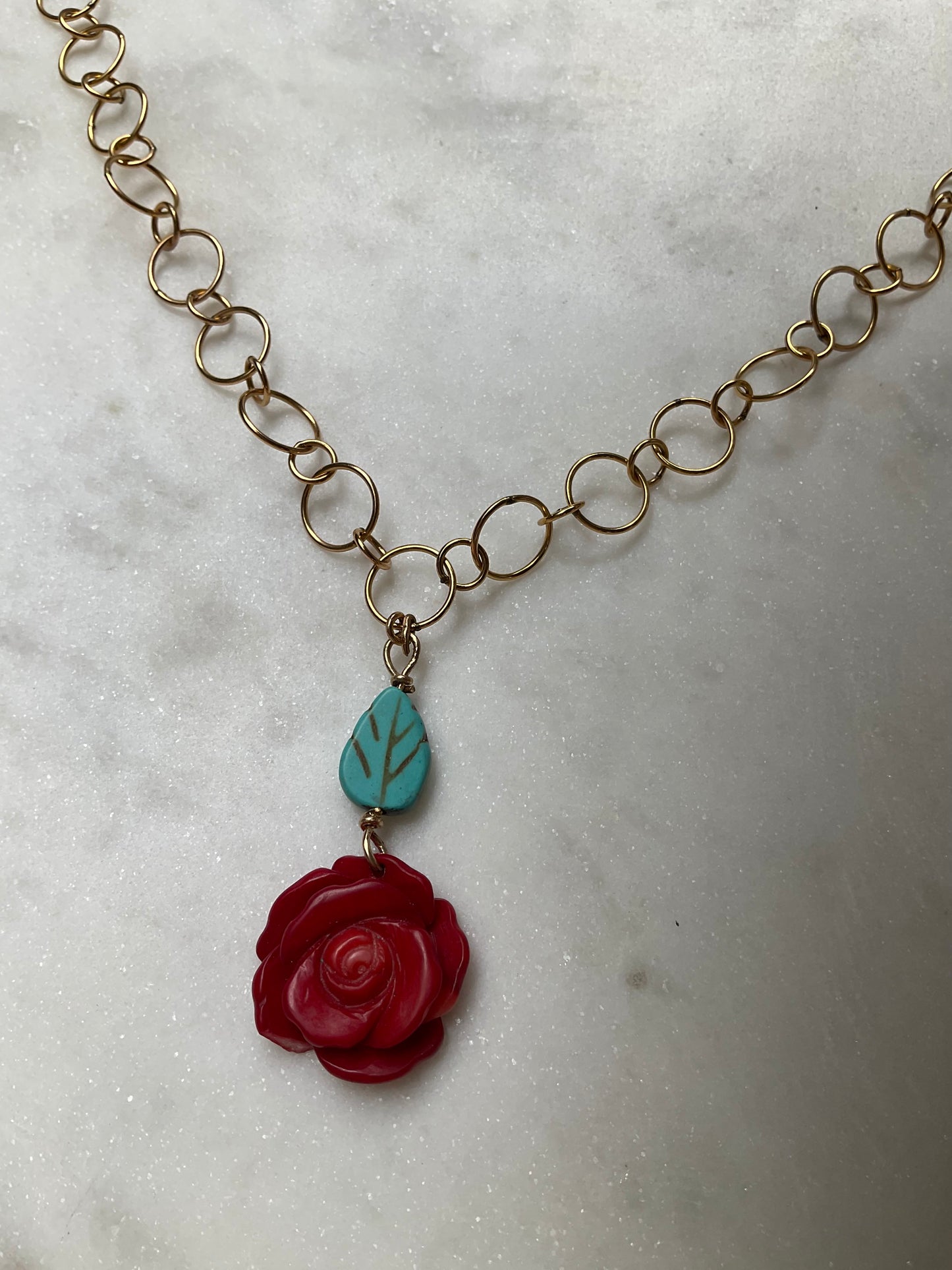 gold filled chain necklace with rose coral pendant and turquoise leaf