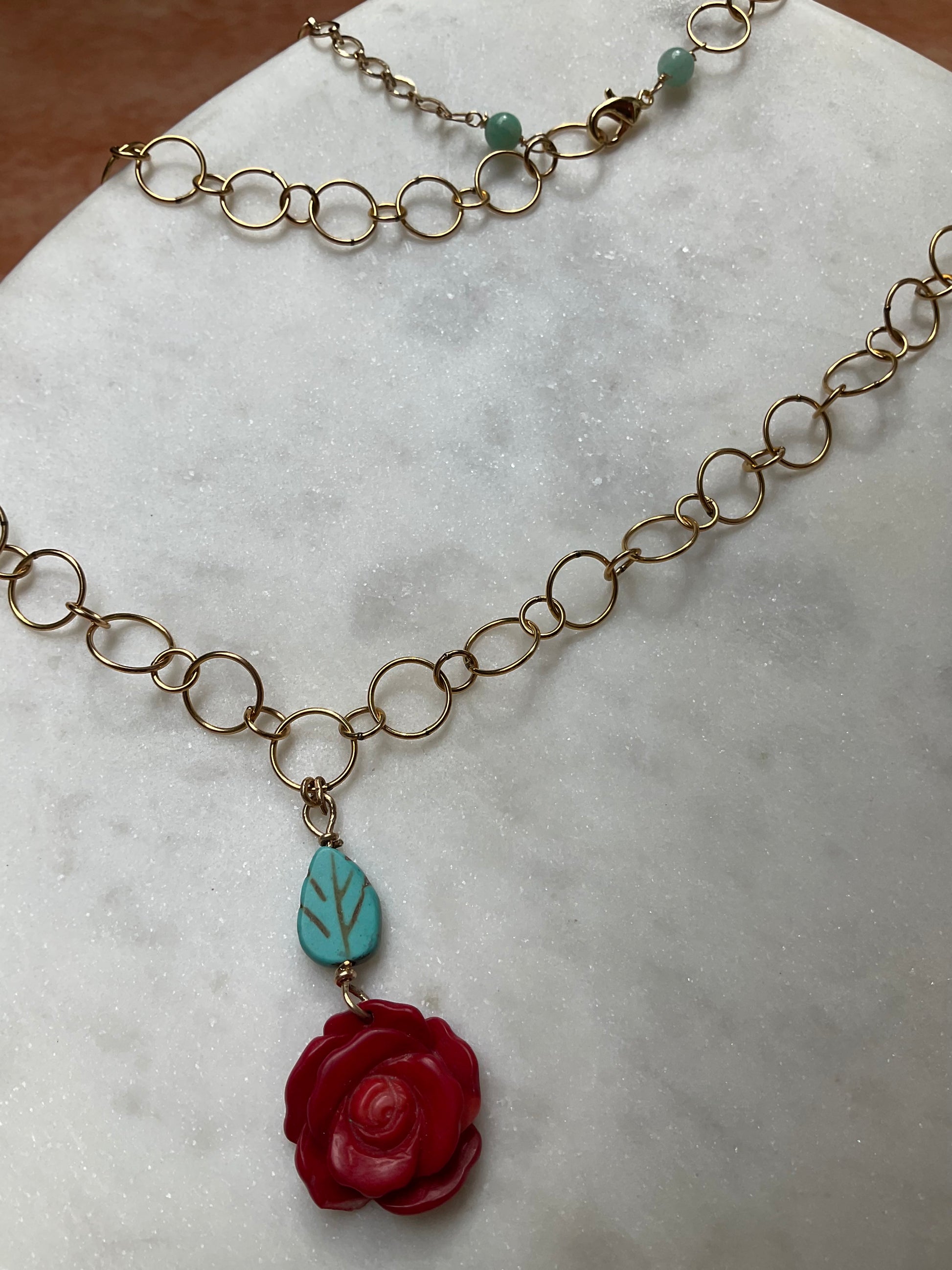 gold filled chain necklace with rose coral pendant and turquoise leaf